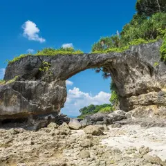 Skalny łuk na plaży, jakby stworzony przez naturę na Andamanach. Słońce, morze i bujna roślinność.