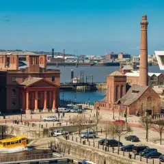 Albert Dock w Liverpool miasto, z żółtym amfibią w wodzie i charakterystycznym kominem.