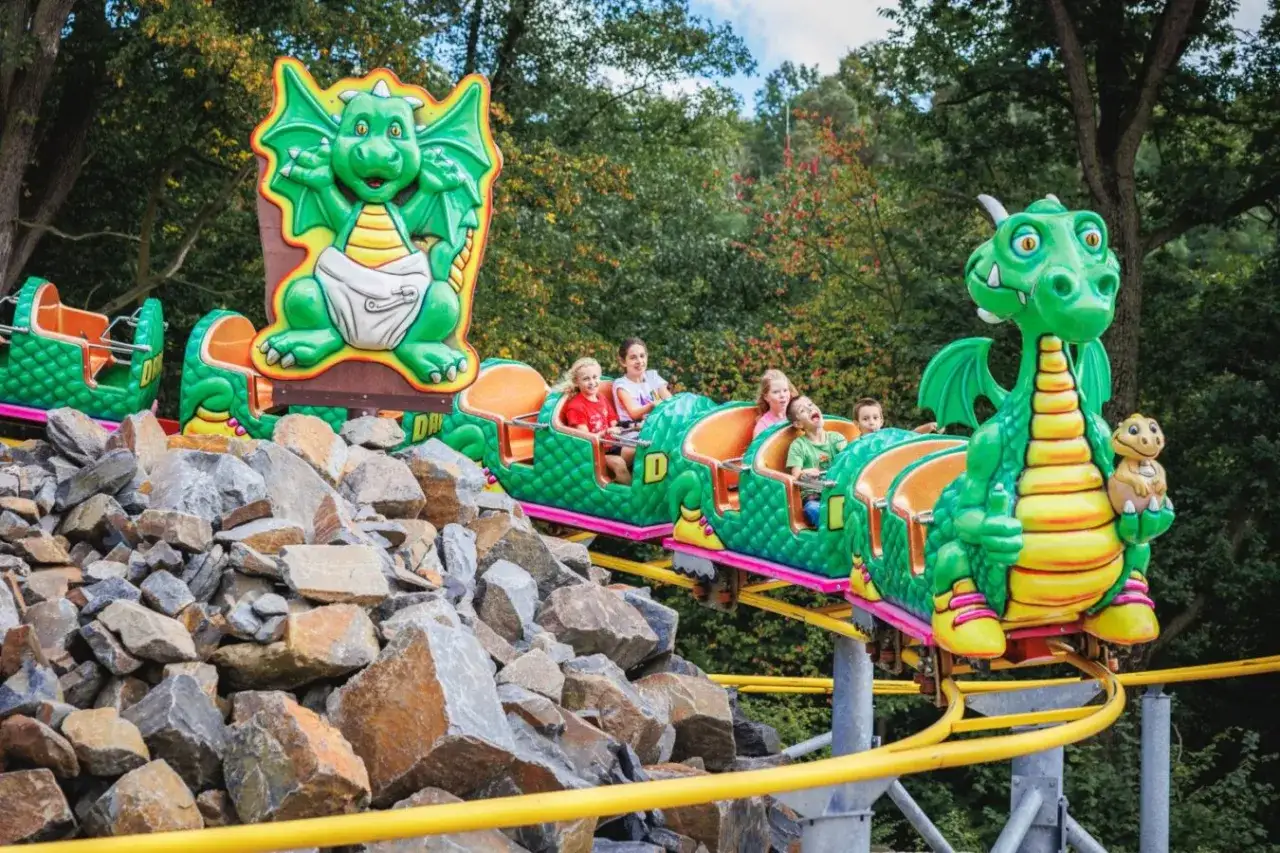 Dzieci bawią się na smoczkowym rollercoasterze w czeskim parku rozrywki.